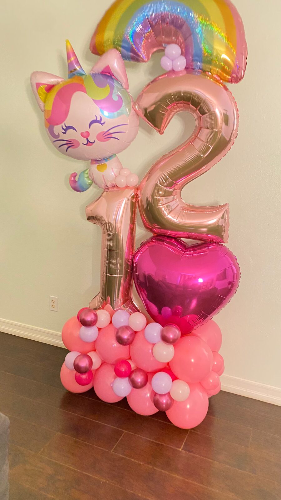 Pink number 12 balloon tower with a kitten foil