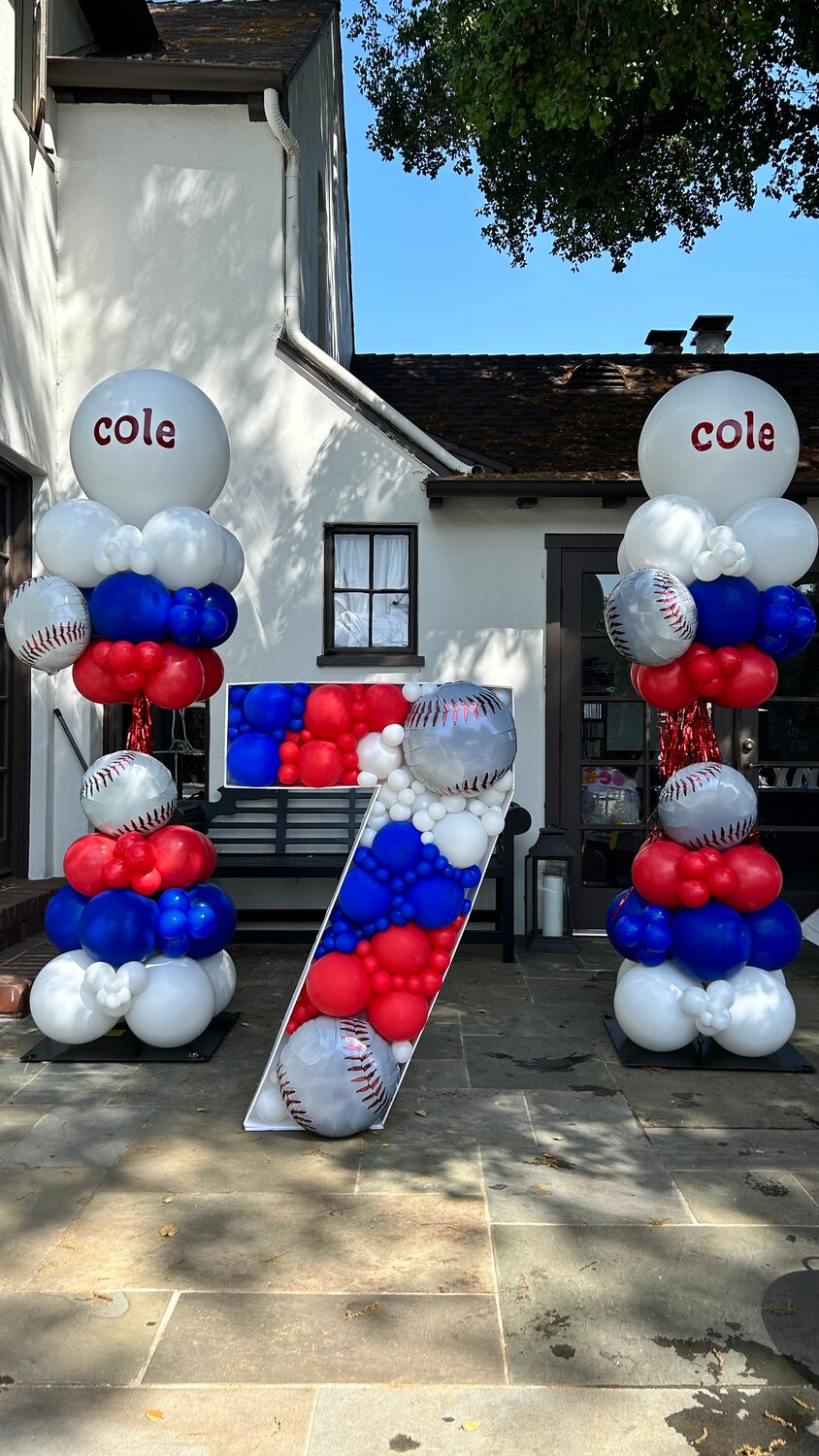 Red, white and blue balloon columns on either side of a doorway