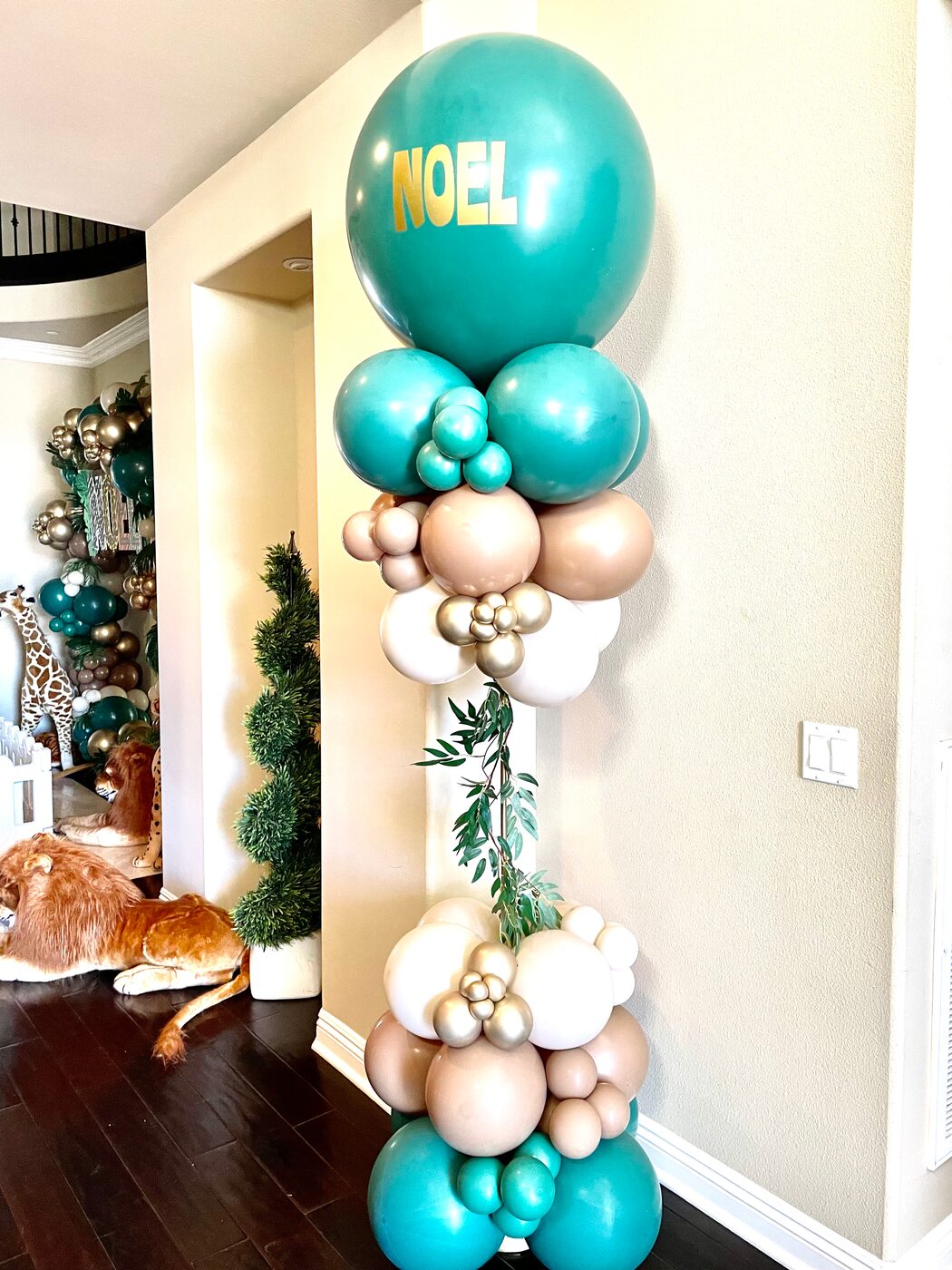Teal, rose-gold and white balloon column in an entryway